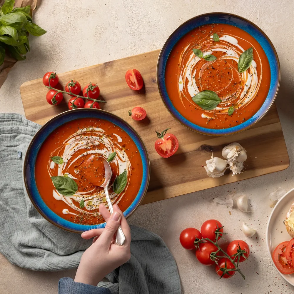 Tomato soup with a cream swirl and basil, styled for Avonmore